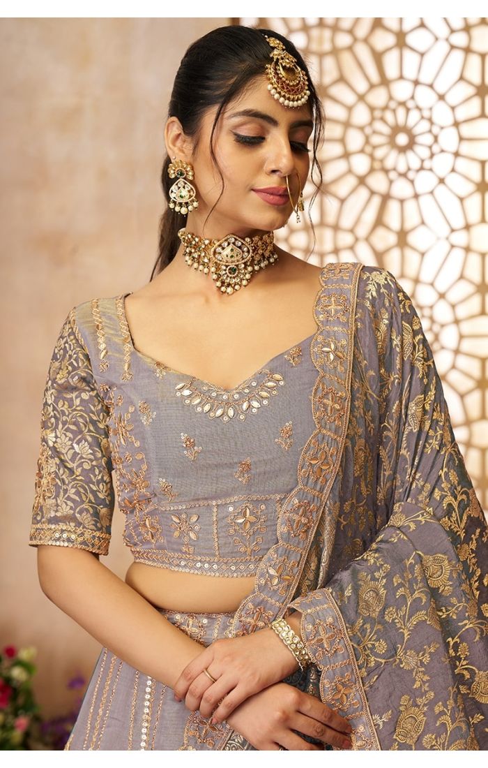 Close-up shot of golden embroidery and Banarasi detailing on onion bridal lehenga blouse.