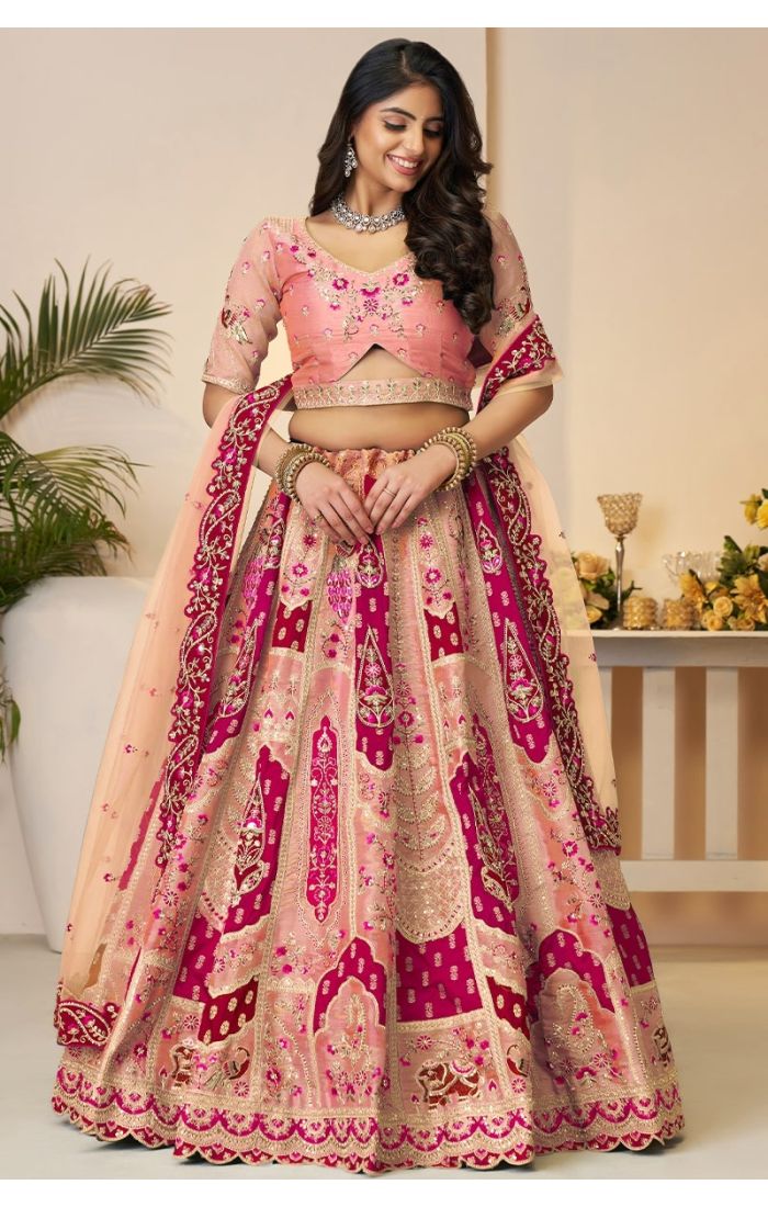 Front view of heavily embroidered onion pink bridal lehenga with flared design