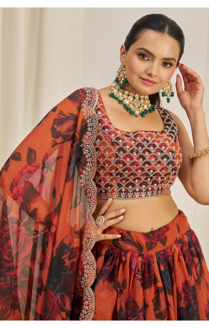 Close-up of embroidered blouse and dupatta of orange floral lehenga