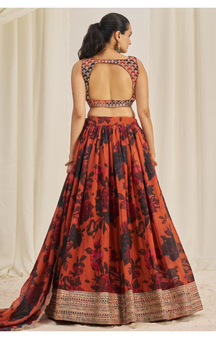 Back view of orange floral organza lehenga choli with open-back blouse