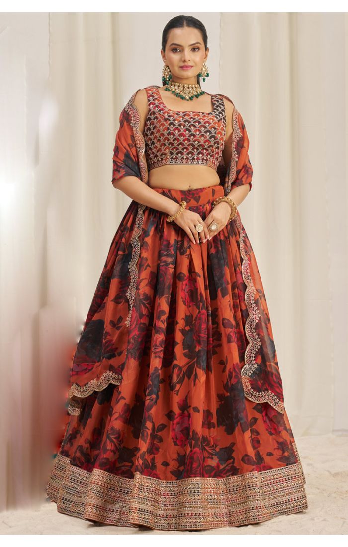 Model wearing orange floral organza lehenga choli front view