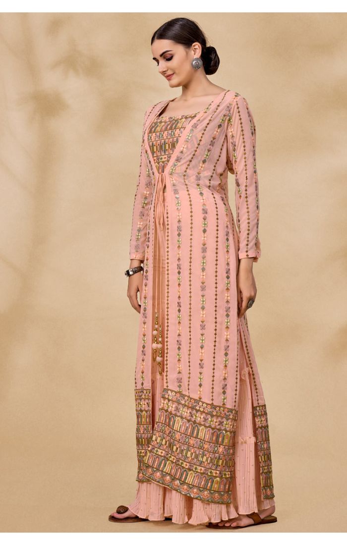 Detail view of long embroidered jacket paired with peach georgette palazzo set for Navratri fusion look.