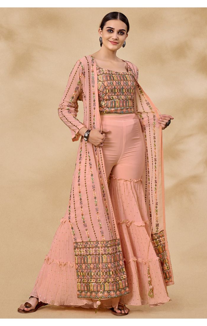 Peach georgette crop top with embroidery and ruffled palazzo set for Navratri, festive ethnic fusion wear.