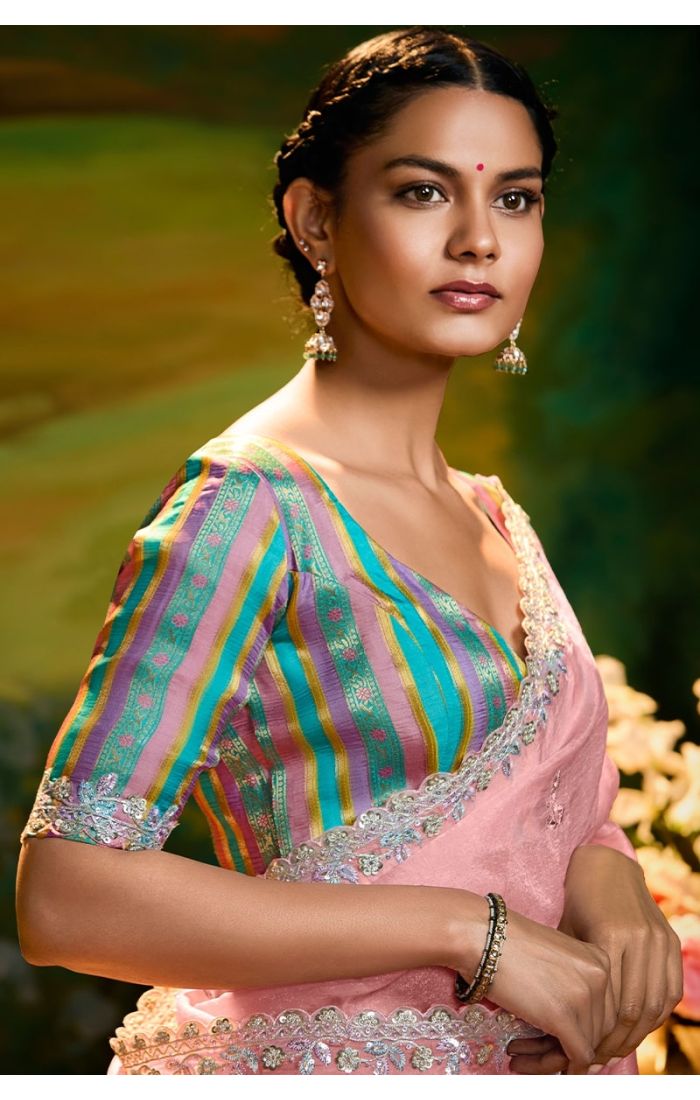 Close-up of zari, sequin, resham, and stone work on peach saree