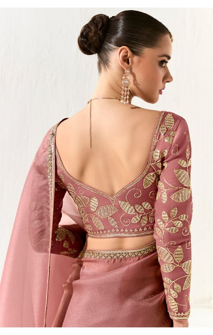  Back view of deep-cut silk blouse with leaf embroidery and zari work