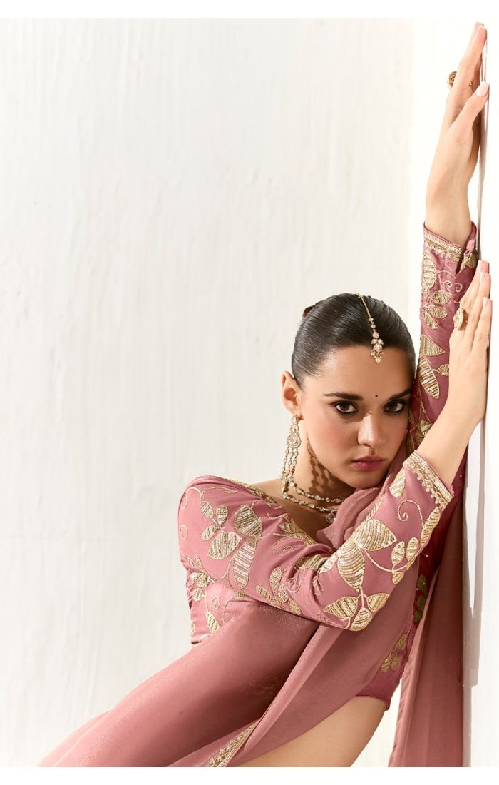  Close-up of blouse embroidery with gold sequins and leaf motifs on peach base