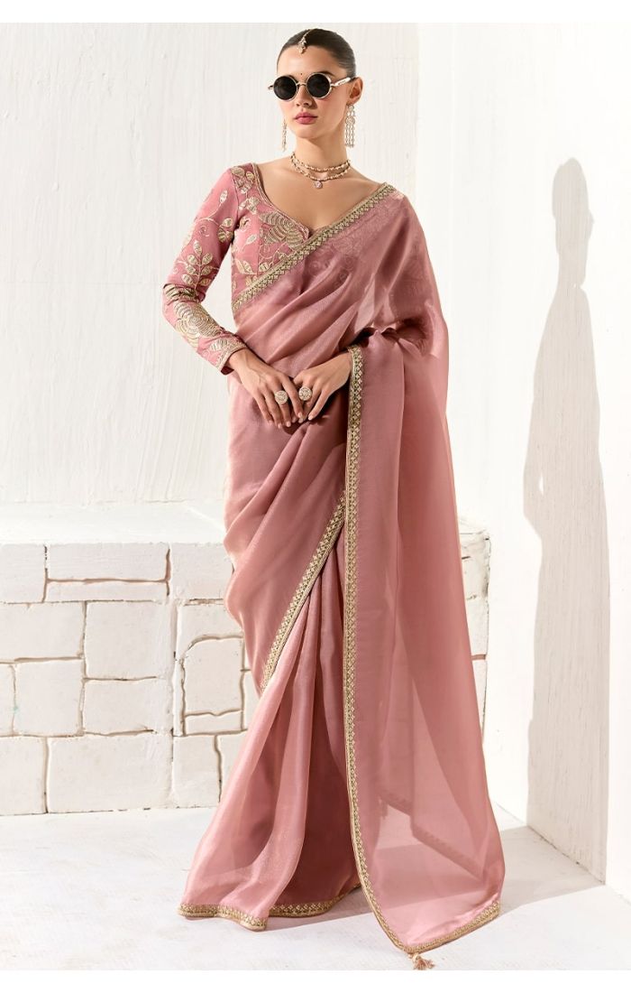  Model wearing peach organza silk saree with embroidered blouse front view