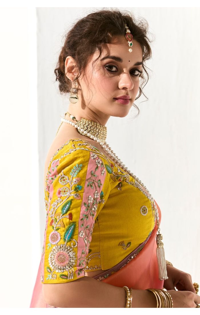 Close-up of yellow blouse with intricate resham and stone embroidery on sleeves and bodice.