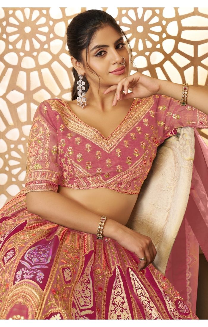 Close-up of pink embroidered blouse with zari and floral aari work