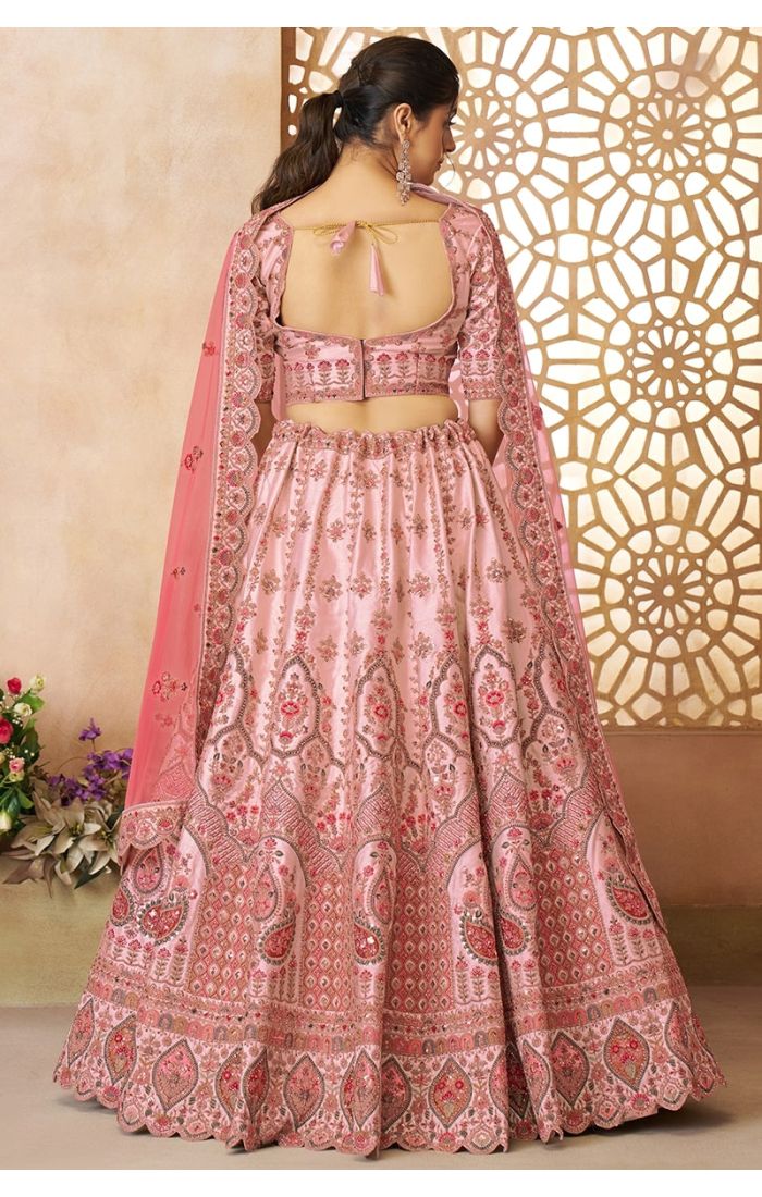 Backside of pink lehenga choli with tie-up blouse and detailed embroideryLet me know when you're ready for the next lehenga!Backside of pink lehenga choli with tie-up blouse and detailed embroidery
