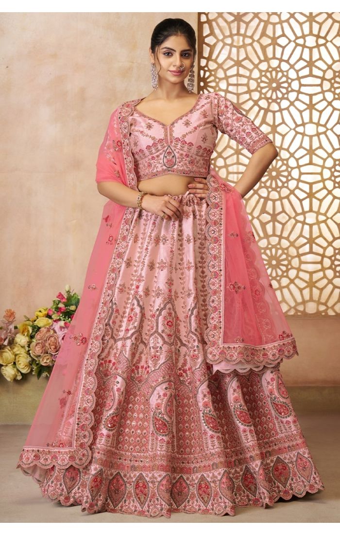 Front view of pink silk bridal lehenga with paisley embroidery and sheer dupatta