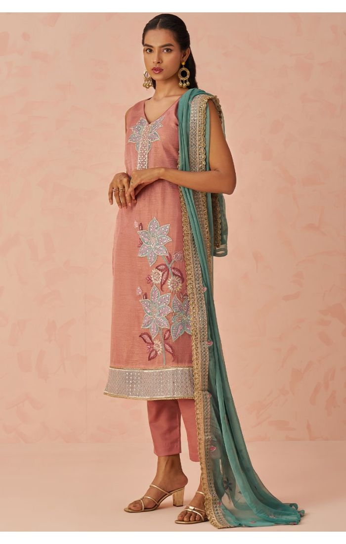 Side pose of pink festive salwar suit with floral embroidery and designer borders