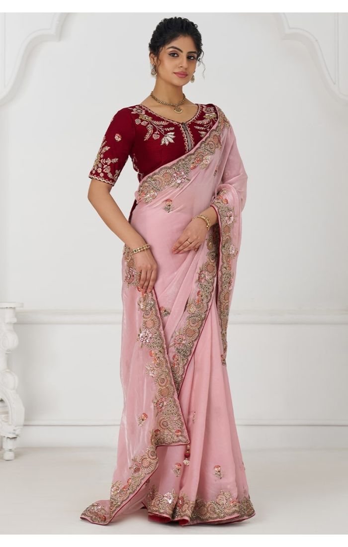  Front pose of pink Fendi silk saree with zari and sequin border, paired with maroon embroidered blouse.