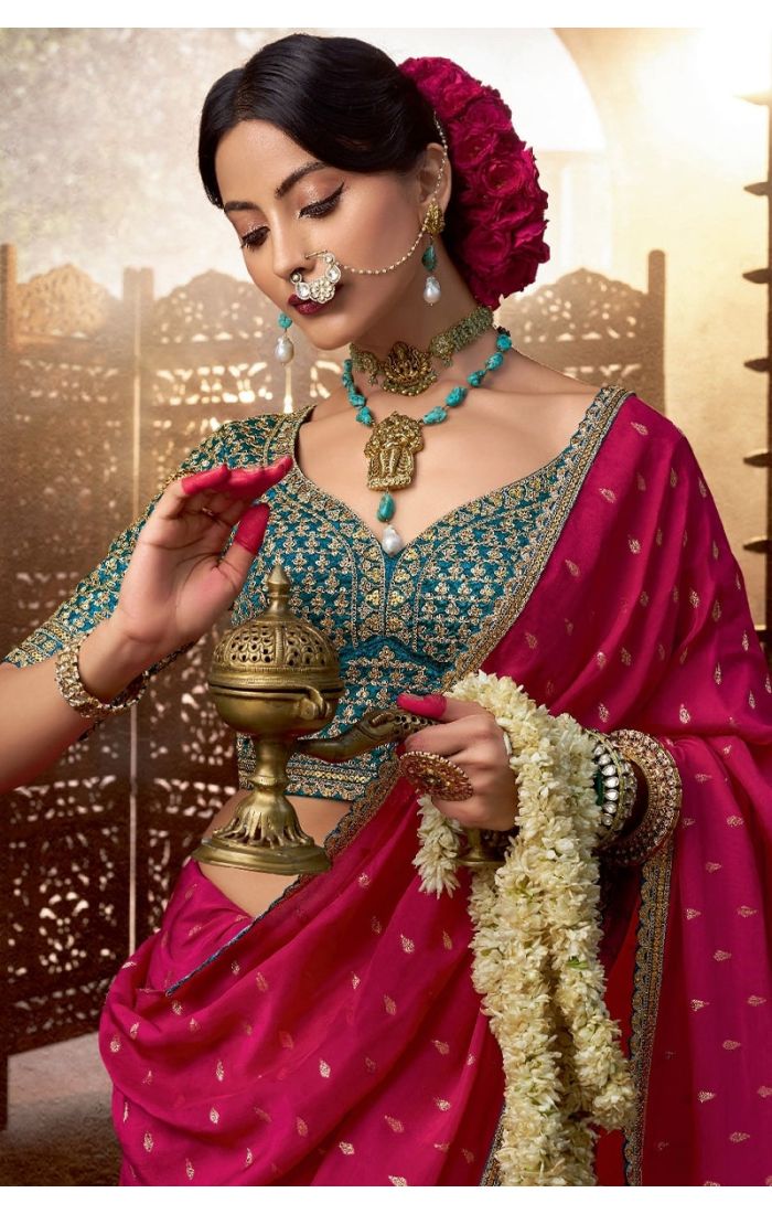 Detailed close-up of resham embroidery on pink saree