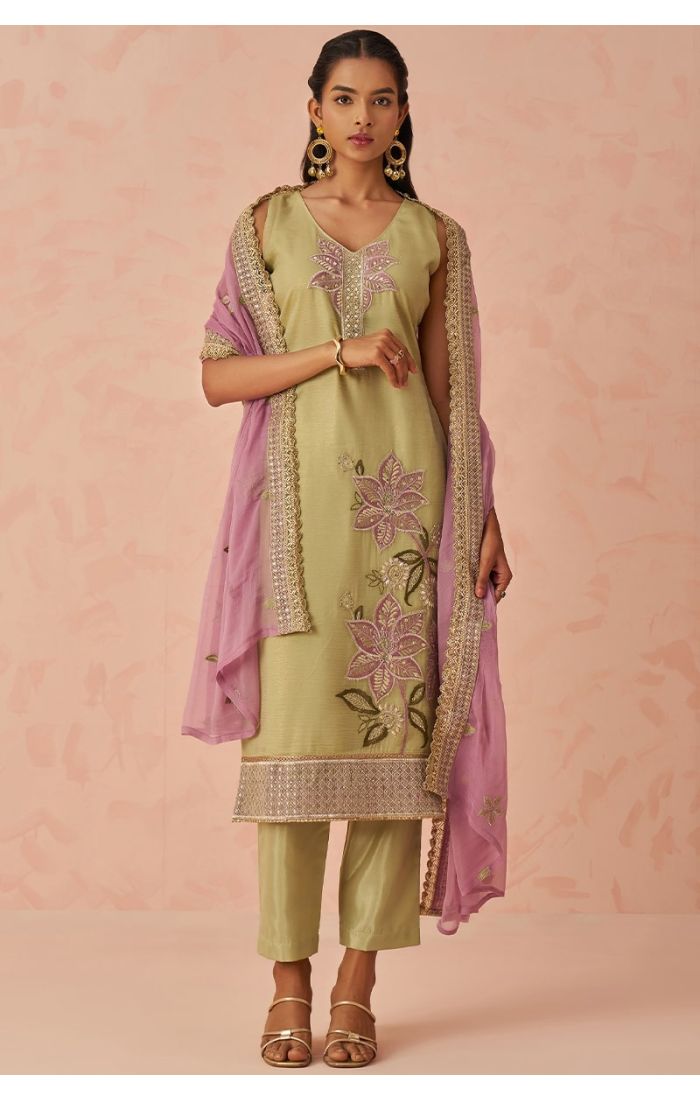 Front side angle of pista green salwar kameez with pink dupatta, showcasing heavy floral embroidery work