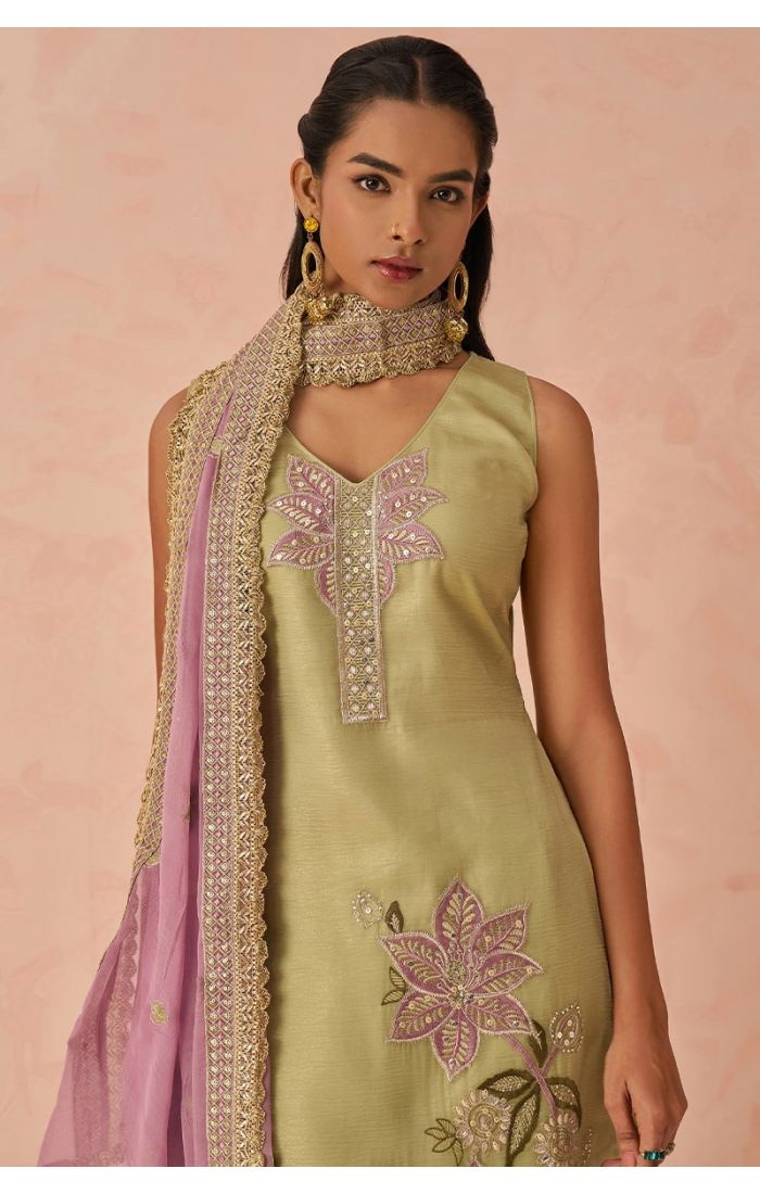Close-up of neckline and embroidery details on pista green silk salwar kameez with pink dupatta