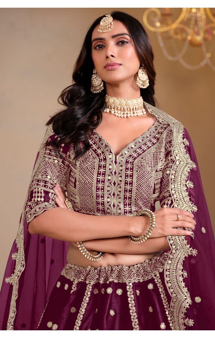 Close-up of blouse detailing and neckline embroidery in plum lehenga choli set