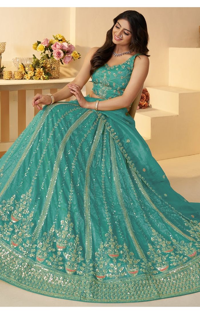 Sitting pose of model wearing powder blue lehenga for sangeet function – UK ethnic wear