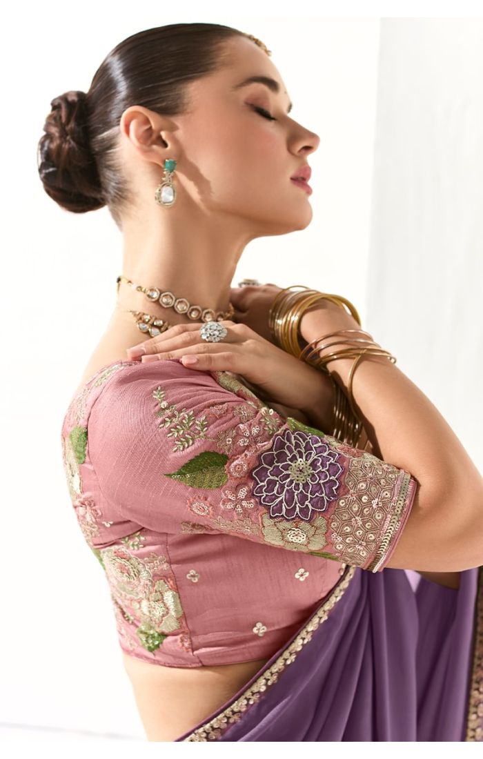 Close-up side profile of pink silk blouse with heavy floral embroidery and purple organza saree.