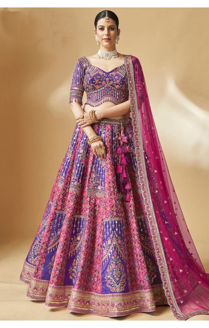Purple silk bridal lehenga choli with sweetheart neckline and heavy embroidery – front view