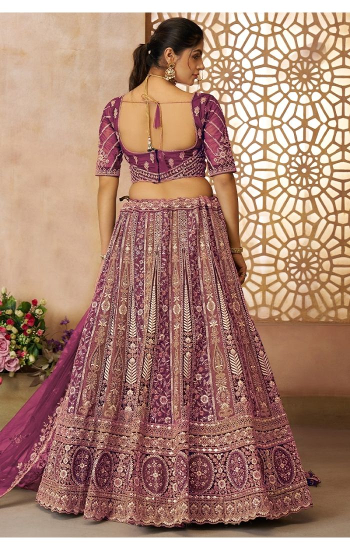 Back design of bridal lehenga in soft net with tassel blouse and flare skirt