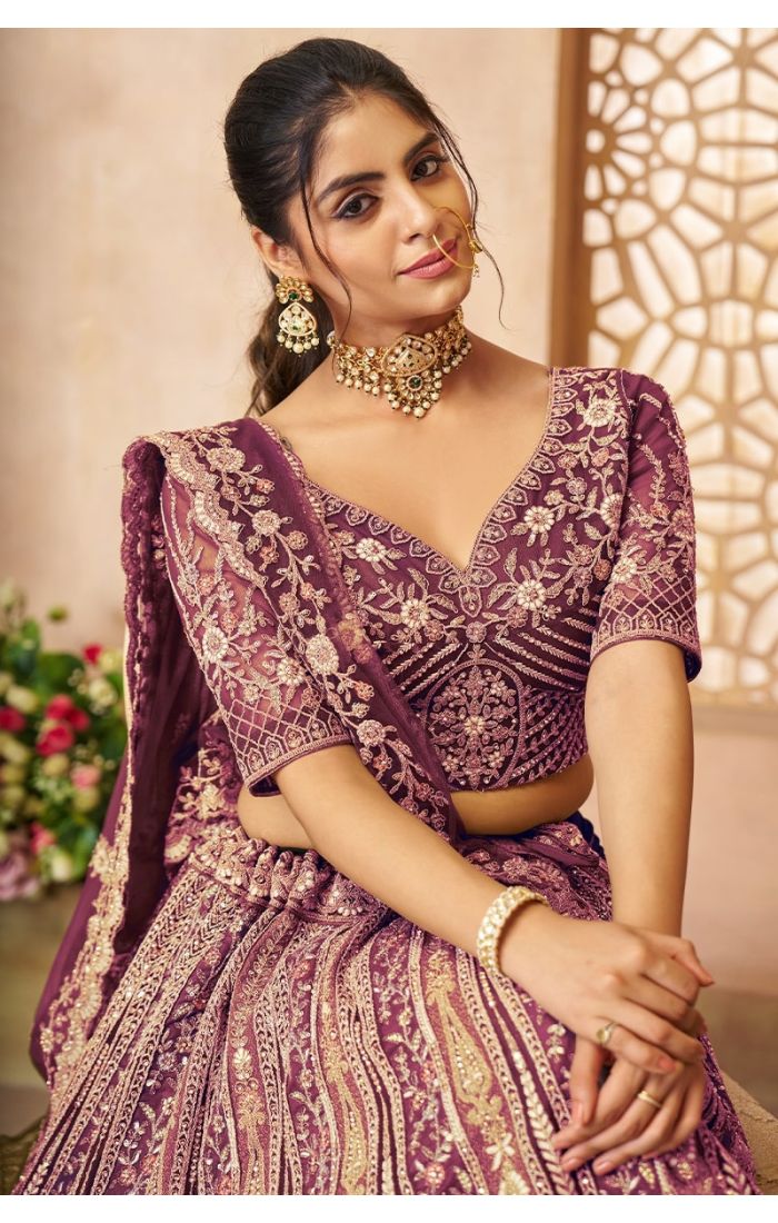 Close-up of neckline and blouse embroidery in designer purple bridal lehenga