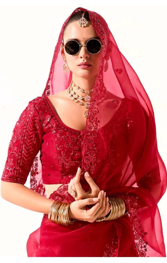 Close-up of blouse embroidery and saree pallu with floral motifs