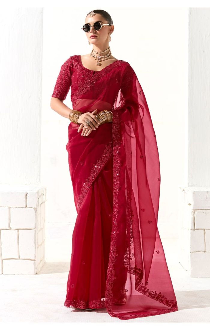 Model wearing rani pink organza silk saree front view with sequin and zari embroidery