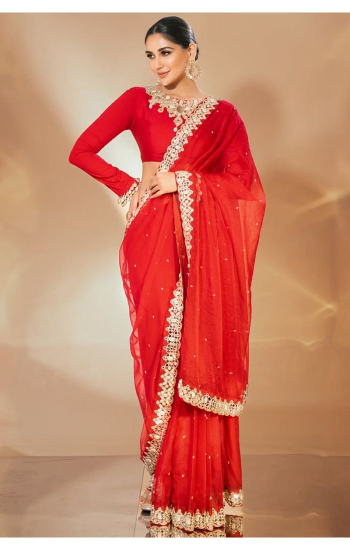 Full front view of red organza saree with mirror and zari work, ideal for festive occasions.