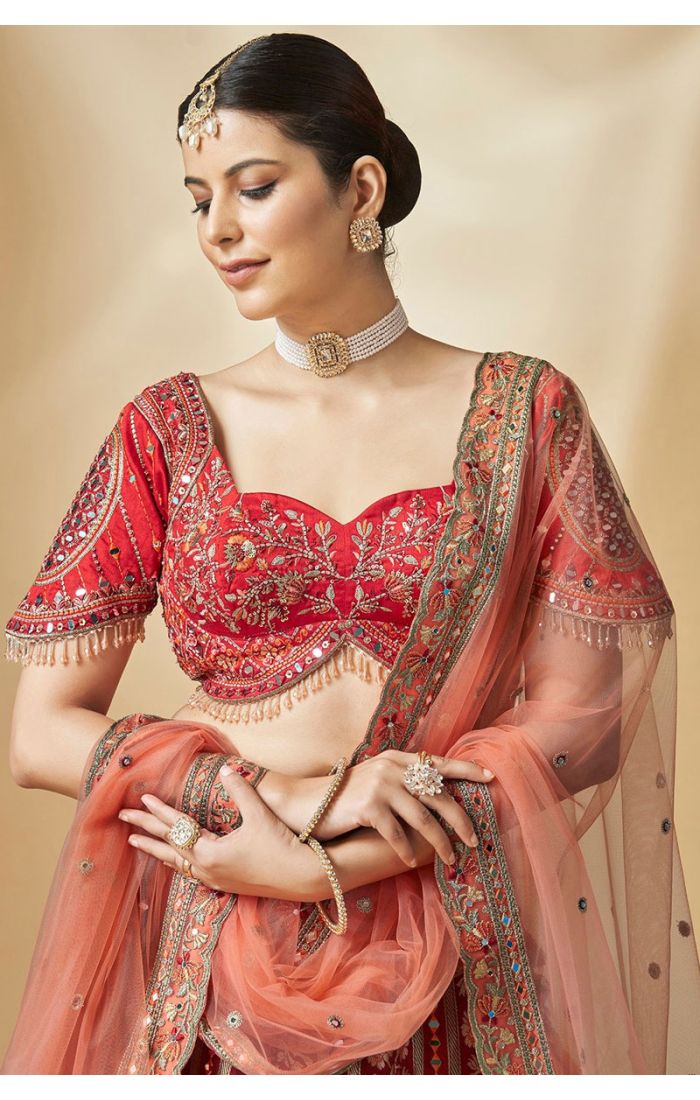 Close-up of embroidered red silk bridal blouse with sweetheart neckline