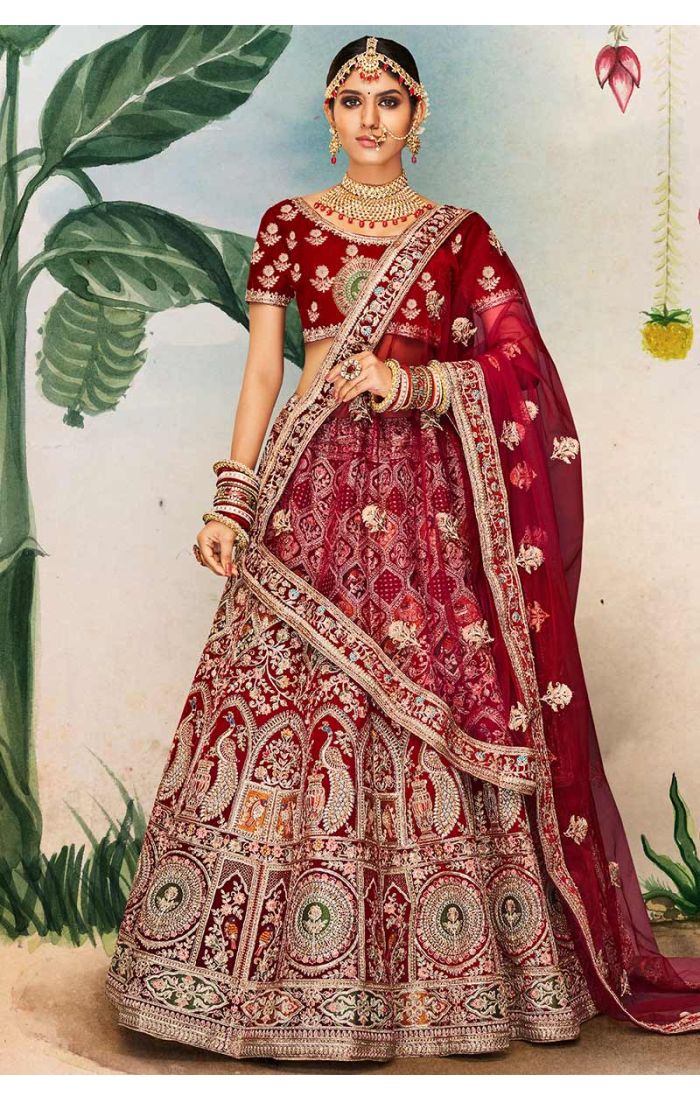 Full view of red velvet bridal lehenga with heavy embroidery, peacock and temple motifs, royal bridal wear.