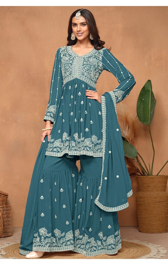  Front view of royal blue georgette sharara suit with heavy embroidery and sequins.