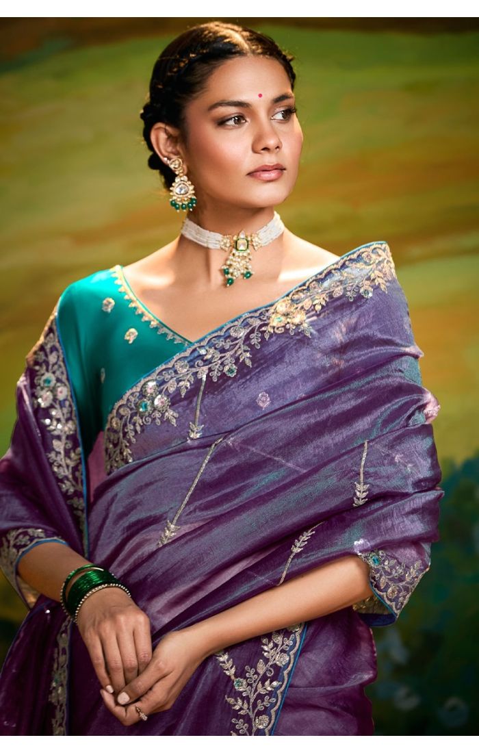 Close-up of zari and resham embroidery on purple organza saree with lace border
