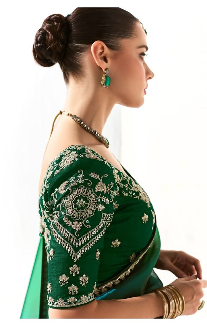 Side profile of model highlighting the neckline embroidery and earrings