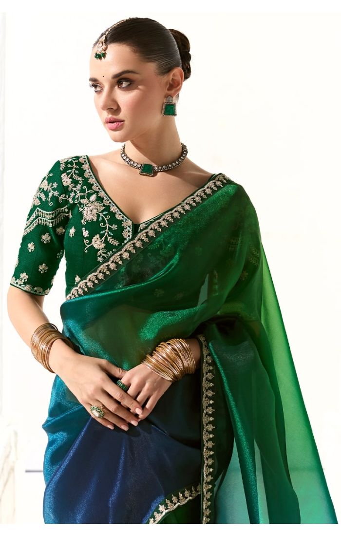 Close-up of intricate zari and stone work on blouse sleeve