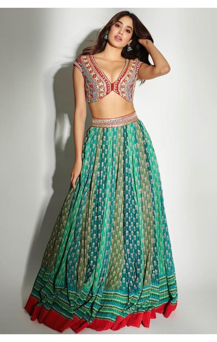 Front pose of Silk Blend green lehenga and heavy mirror embroidered red blouse for wedding and festive occasions.