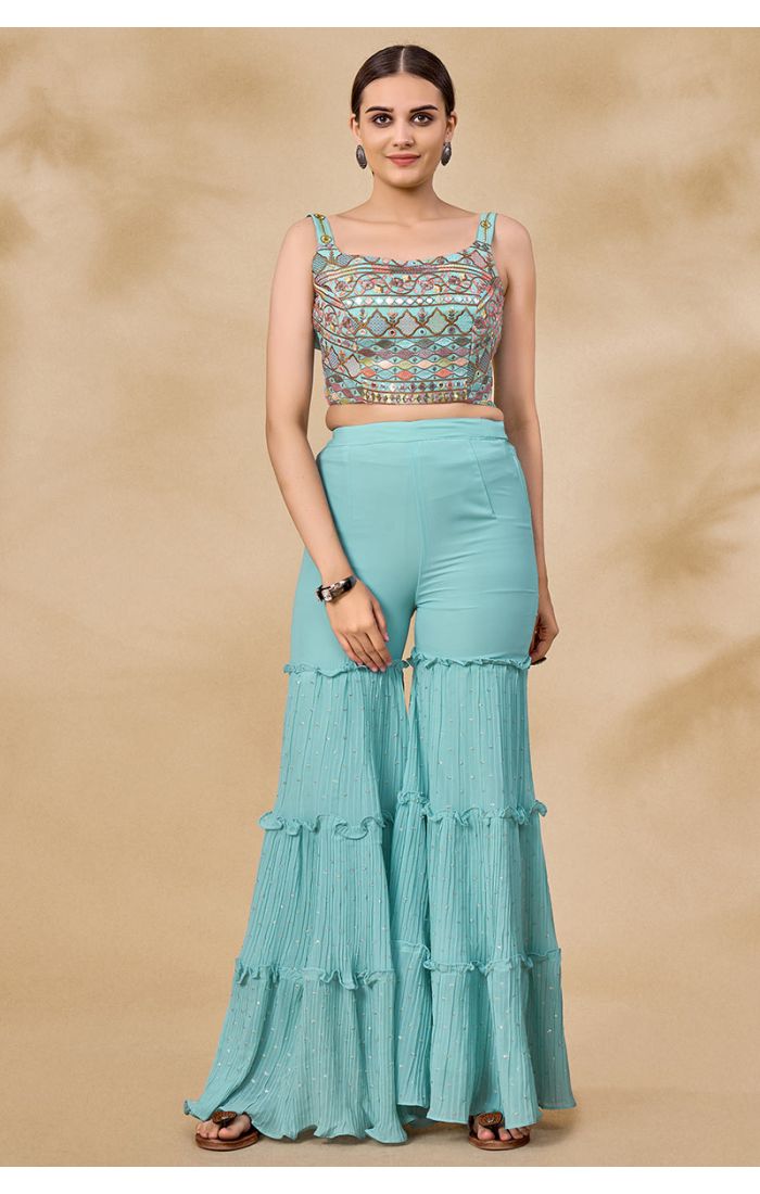 Aqua blue georgette Navratri jacket set with embroidered mirror work crop top and tiered sharara pants — front view