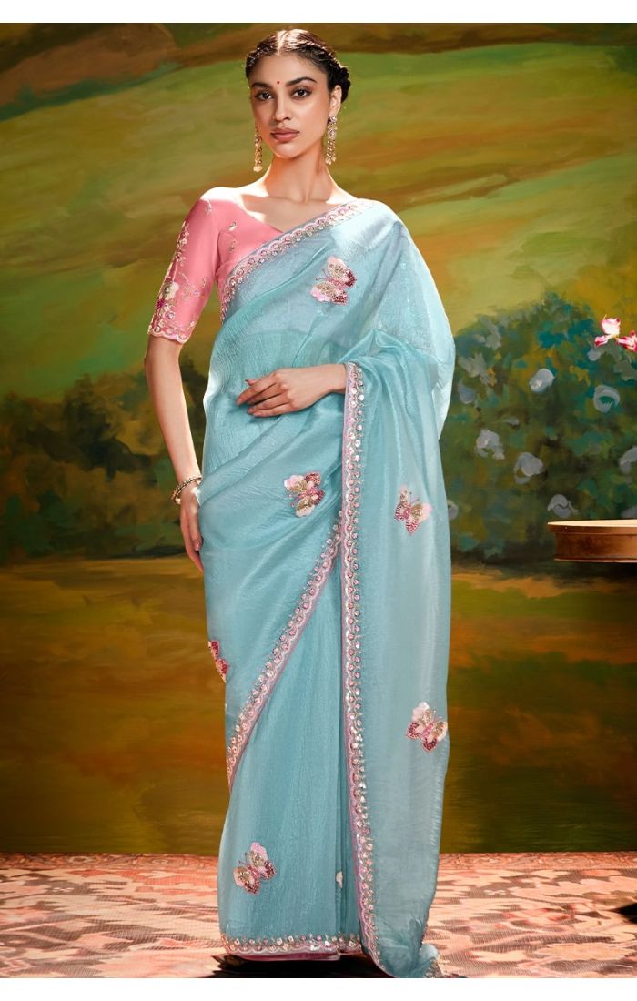 Sky blue organza saree front view with peach raw silk blouse