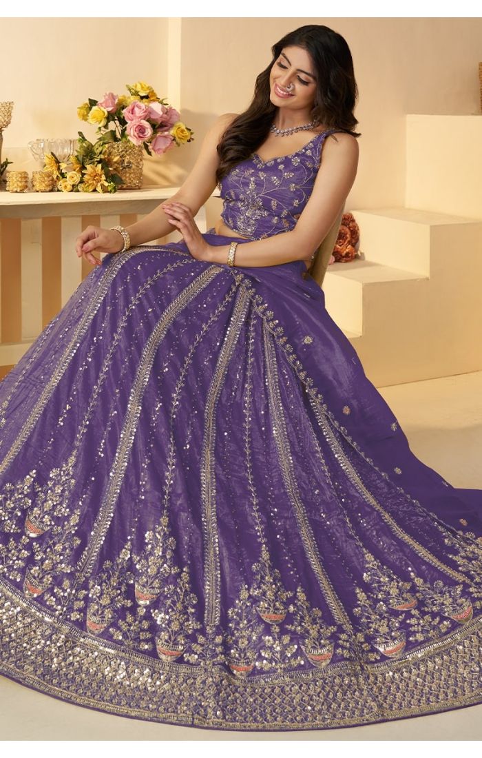  Sitting pose showcasing detailed embroidery of purple bridal lehenga – Appelle Fashion
