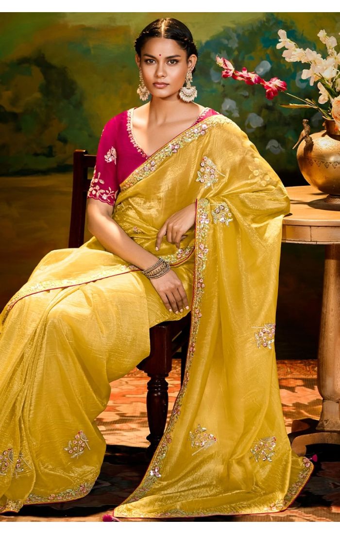 Sitting Detailed embroidery and lace border on mustard organza saree with green blouse