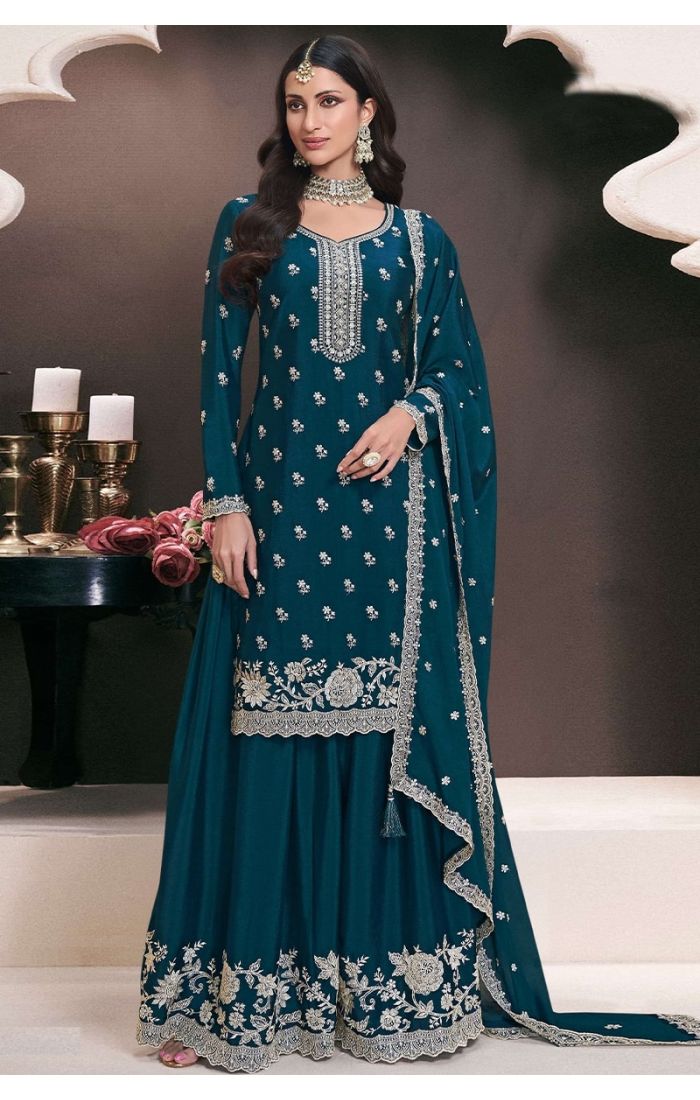 Model wearing teal blue Chinon salwar suit with heavy embroidery and palazzo set