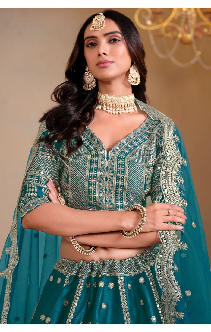 Close-up of teal silk blouse with intricate mirror and thread embroidery – Appelle Fashion