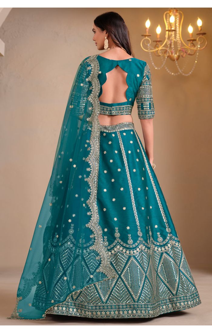 Model wearing teal mirror embroidered lehenga choli with net dupatta – full view