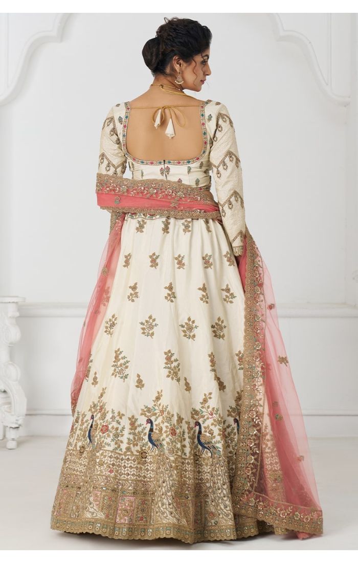 Back view of embroidered white lehenga with peacock motif border